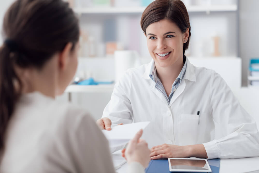 Smiling female doctor with a patient